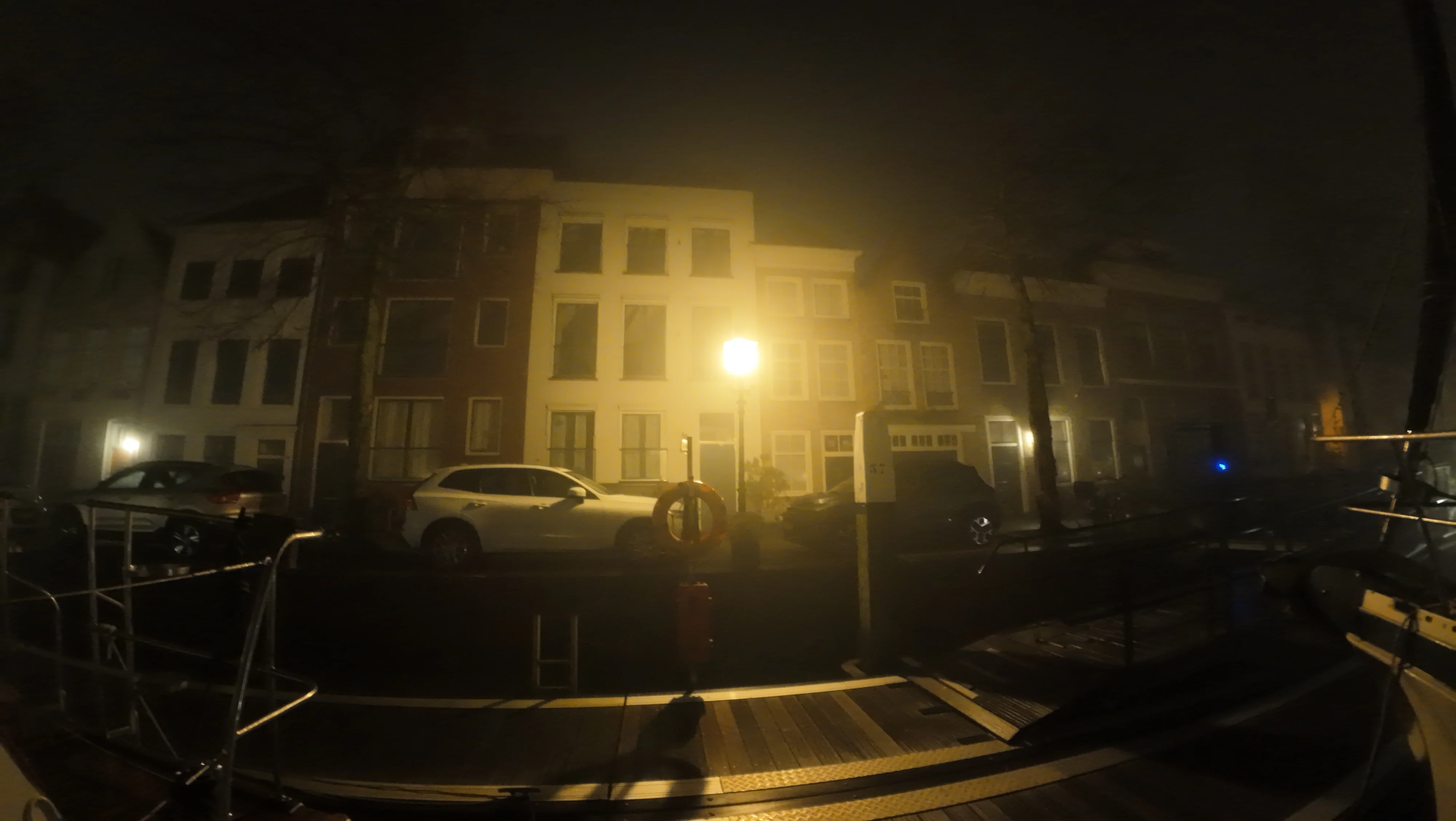 Canal-side facades seen through fog and lamplight